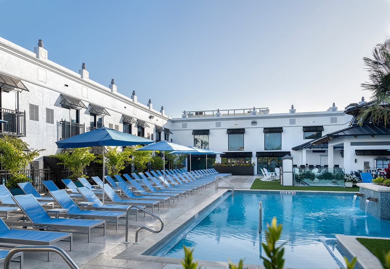 Pool and white colonial facade at Inn on Fifth in downtown Naples, Florida
