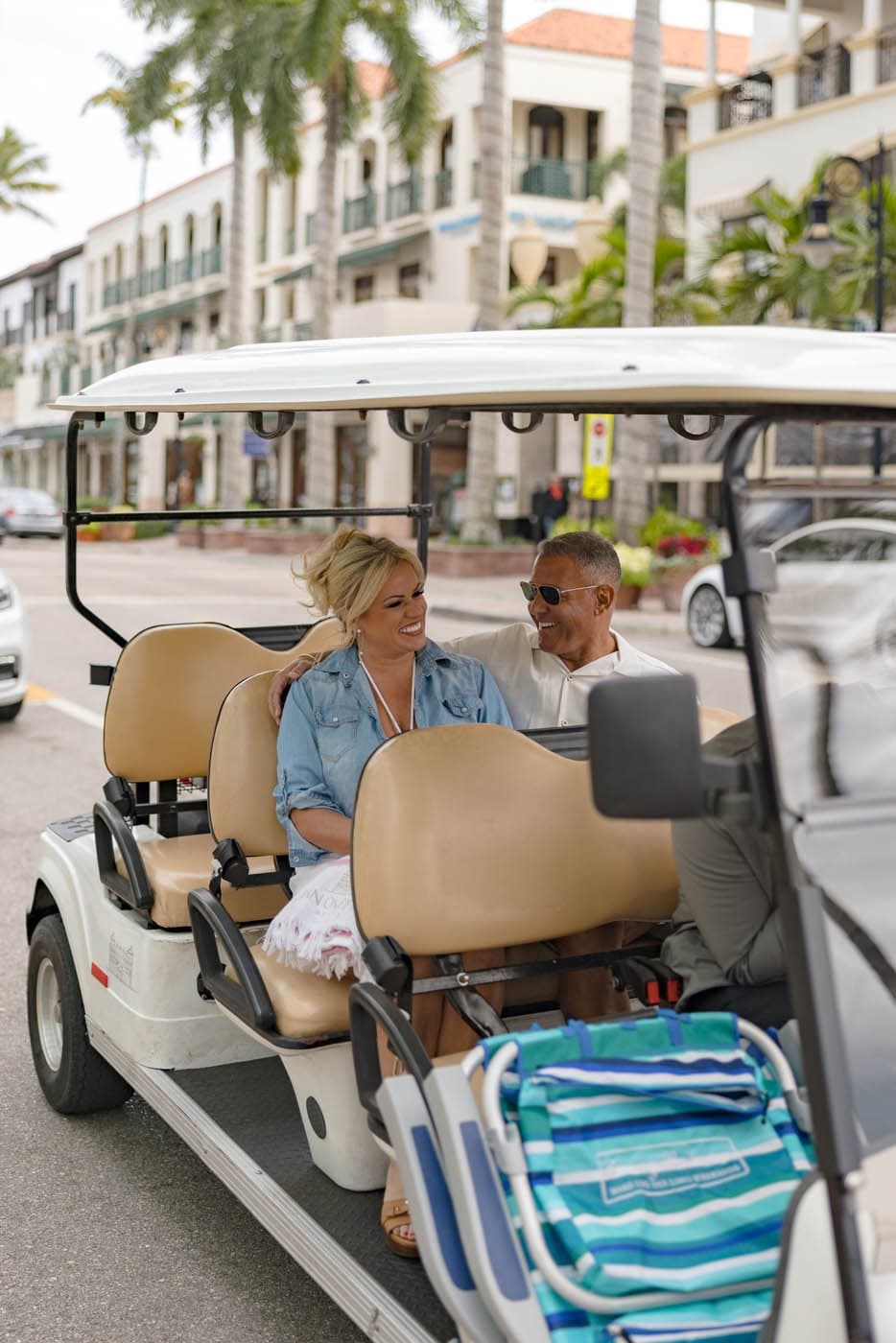 Couple riding a golf cart at a golf resort in Naples, Florida