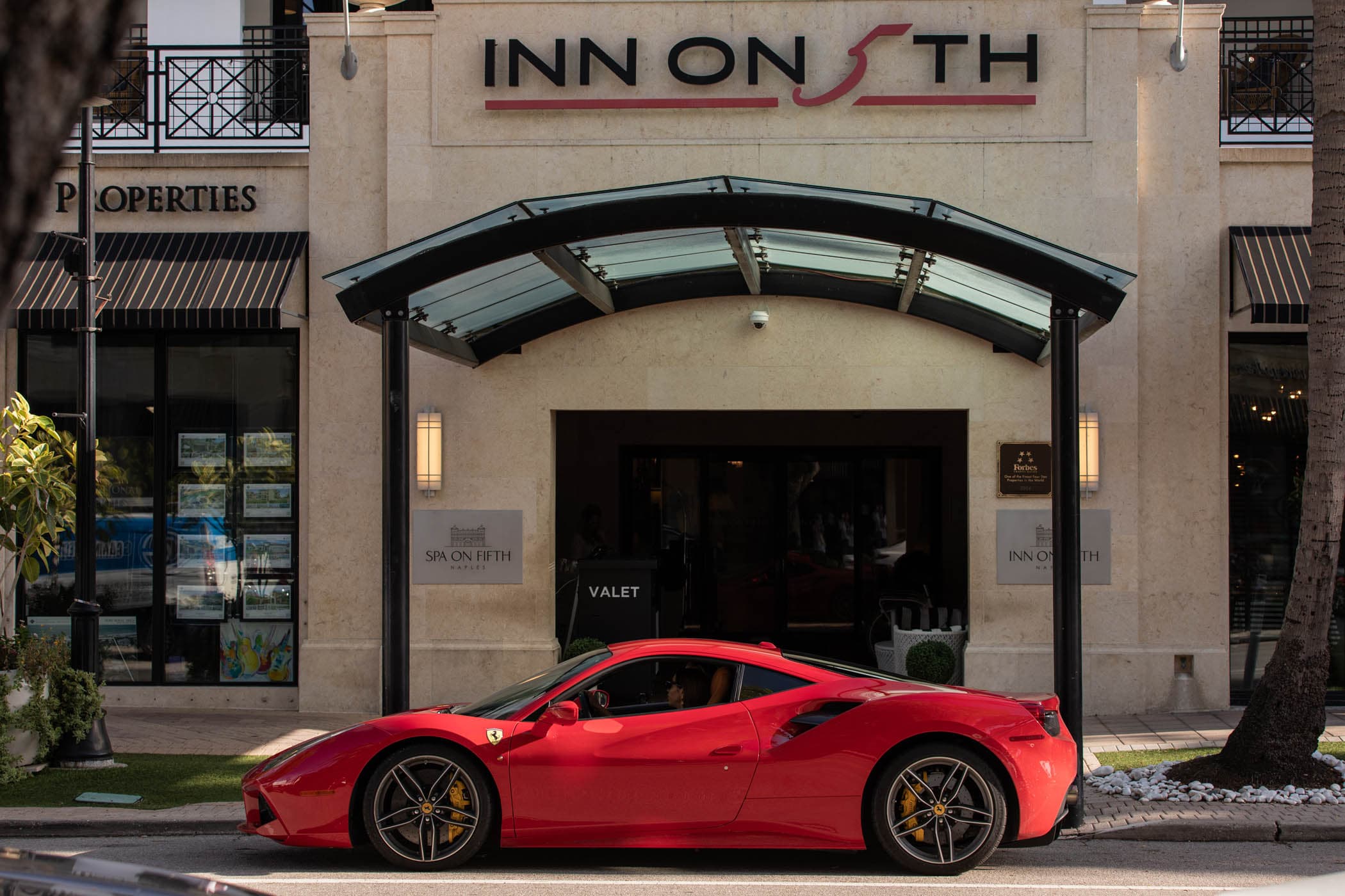 A red sports car out front of Inn on Fifth