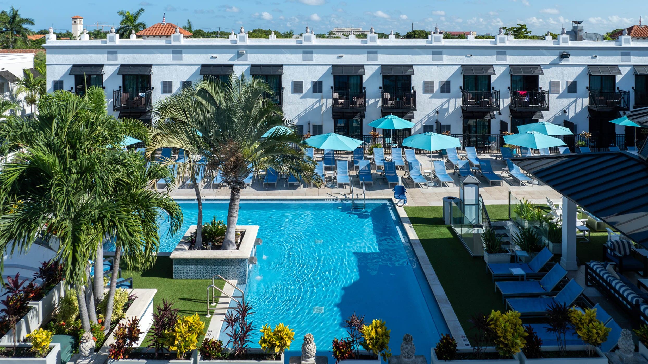 Rooftop pool with cabanas and palms at Inn on Fifth in Naples, Florida