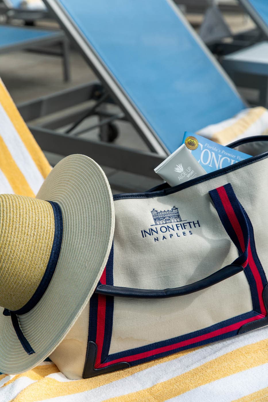 Sun hat and beach tote with towels at a Naples, Florida beach club