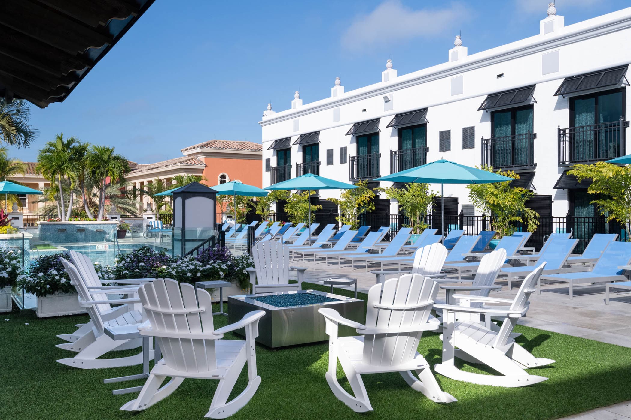 White Adirondack chairs on the lawn at Inn on Fifth in Naples, Florida