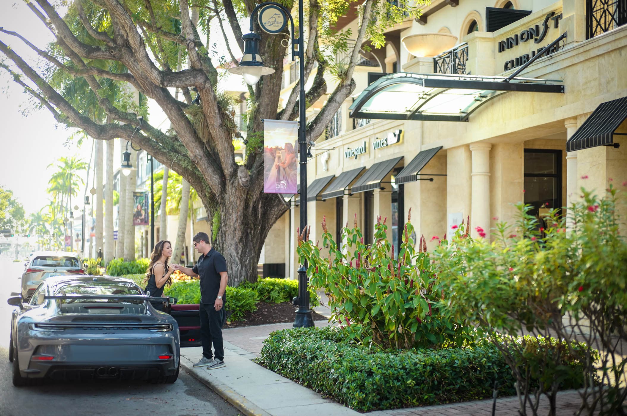 A woman being helped out of a car out front of Inn on Fifth