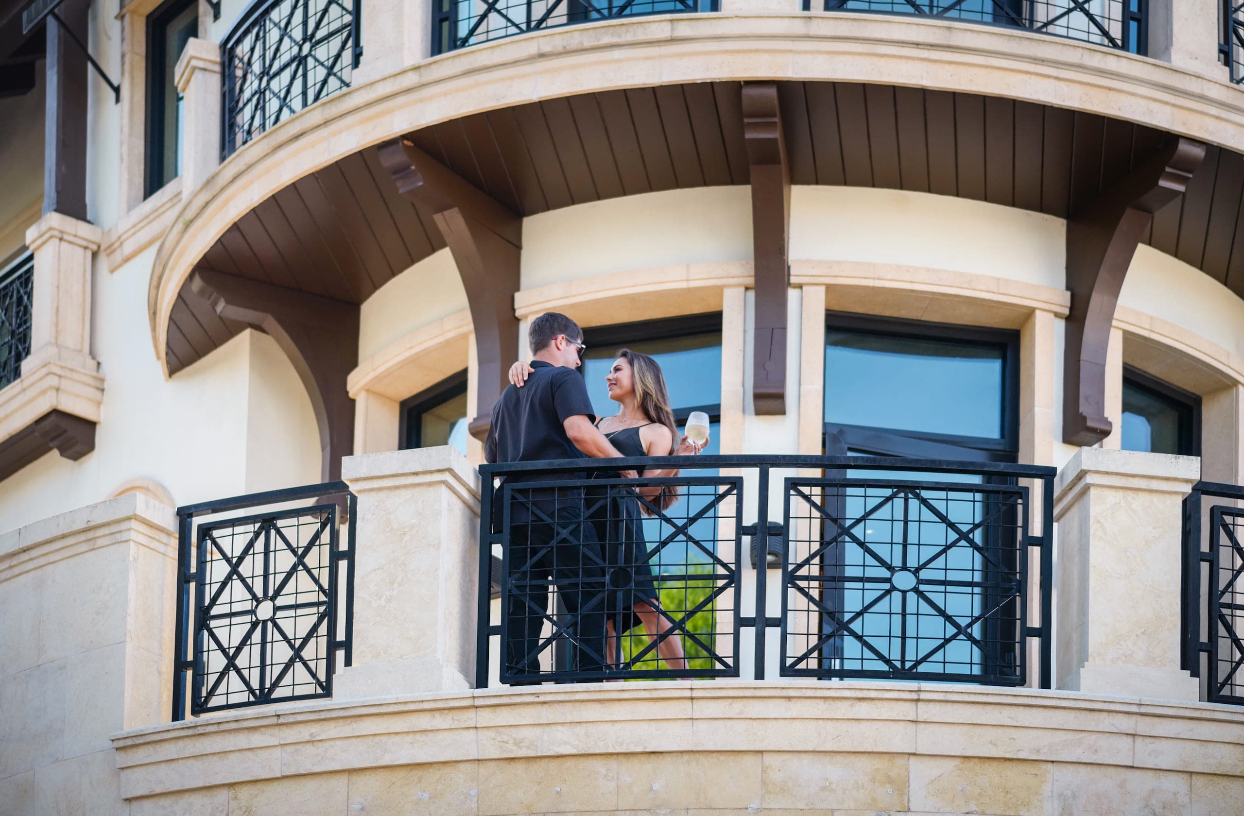 A couple embracing on a balcony at Inn on Fifth
