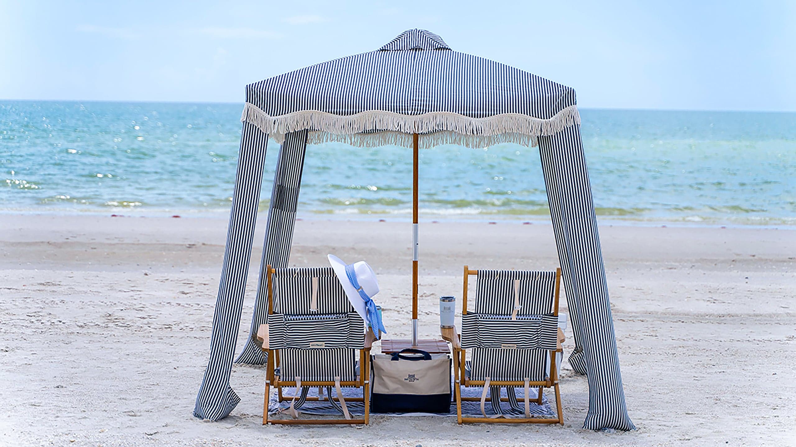 Private beach cabana with loungers at the Inn on Fifth beach club in Naples