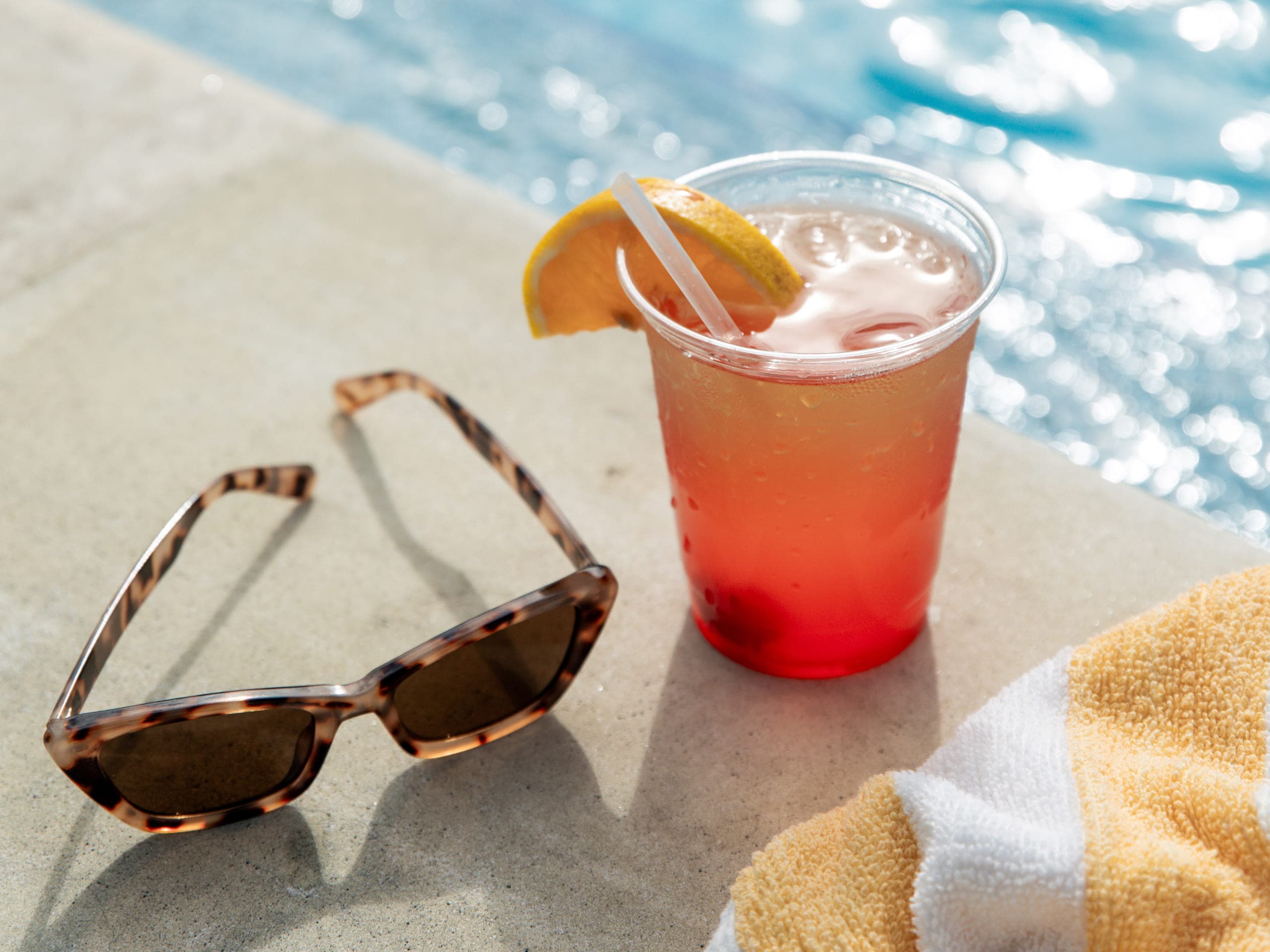 Cocktail and sunglasses beside the pool at Inn on Fifth in Naples, Florida