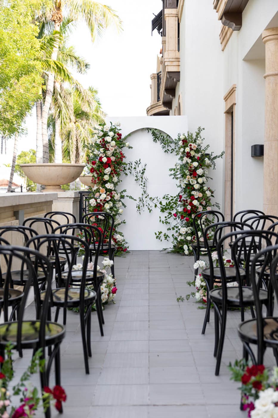 Floral wedding arch with ceremony seating at Inn on Fifth in Naples, Florida