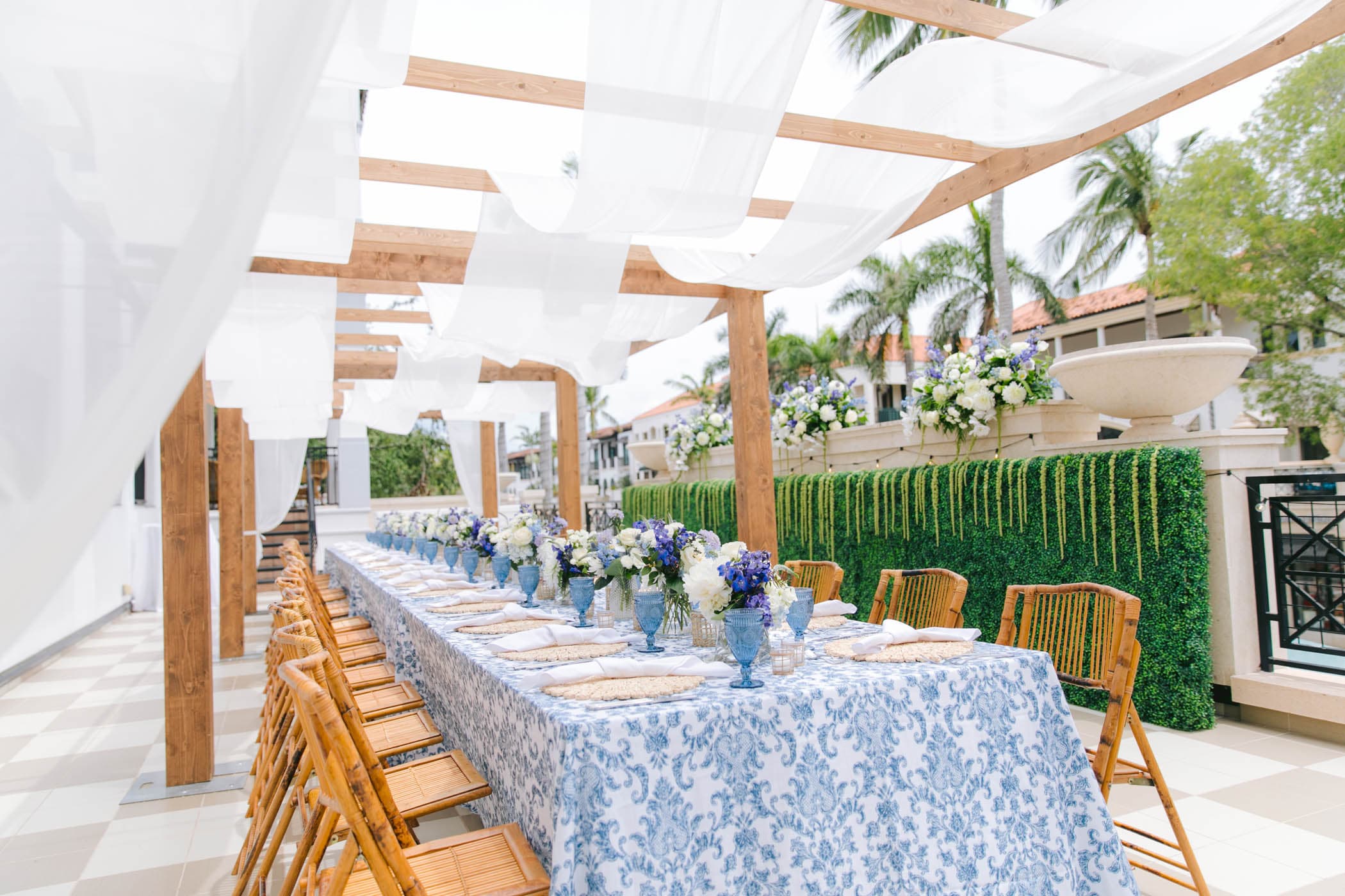 Long banquet table set under a pergola at Inn on Fifth in Naples, Florida