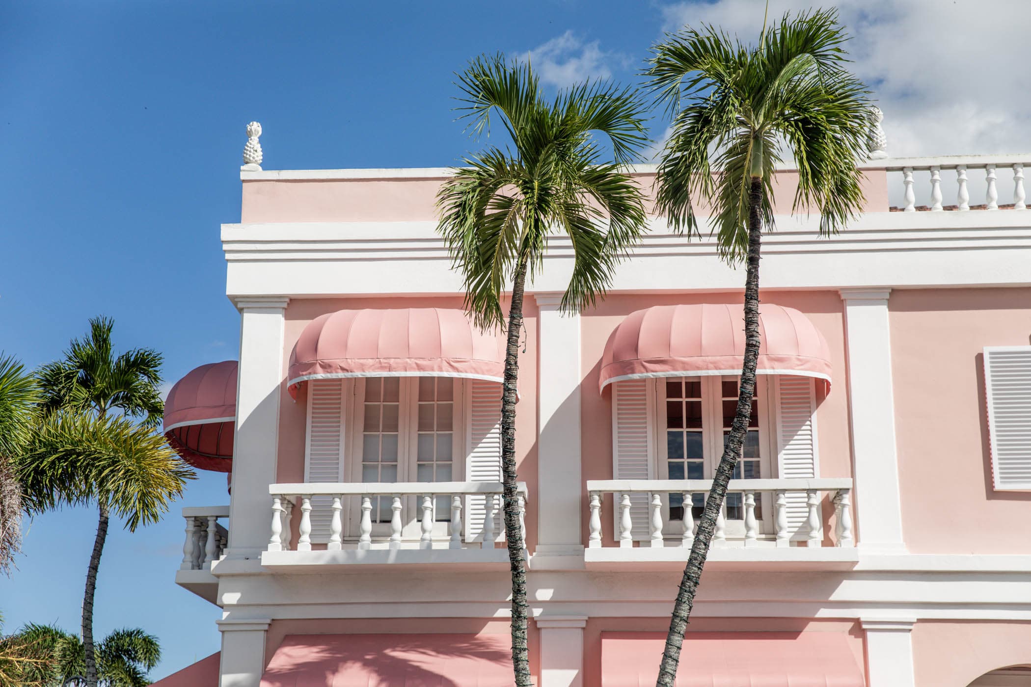 Pink Mediterranean building with palms in downtown Naples, Florida