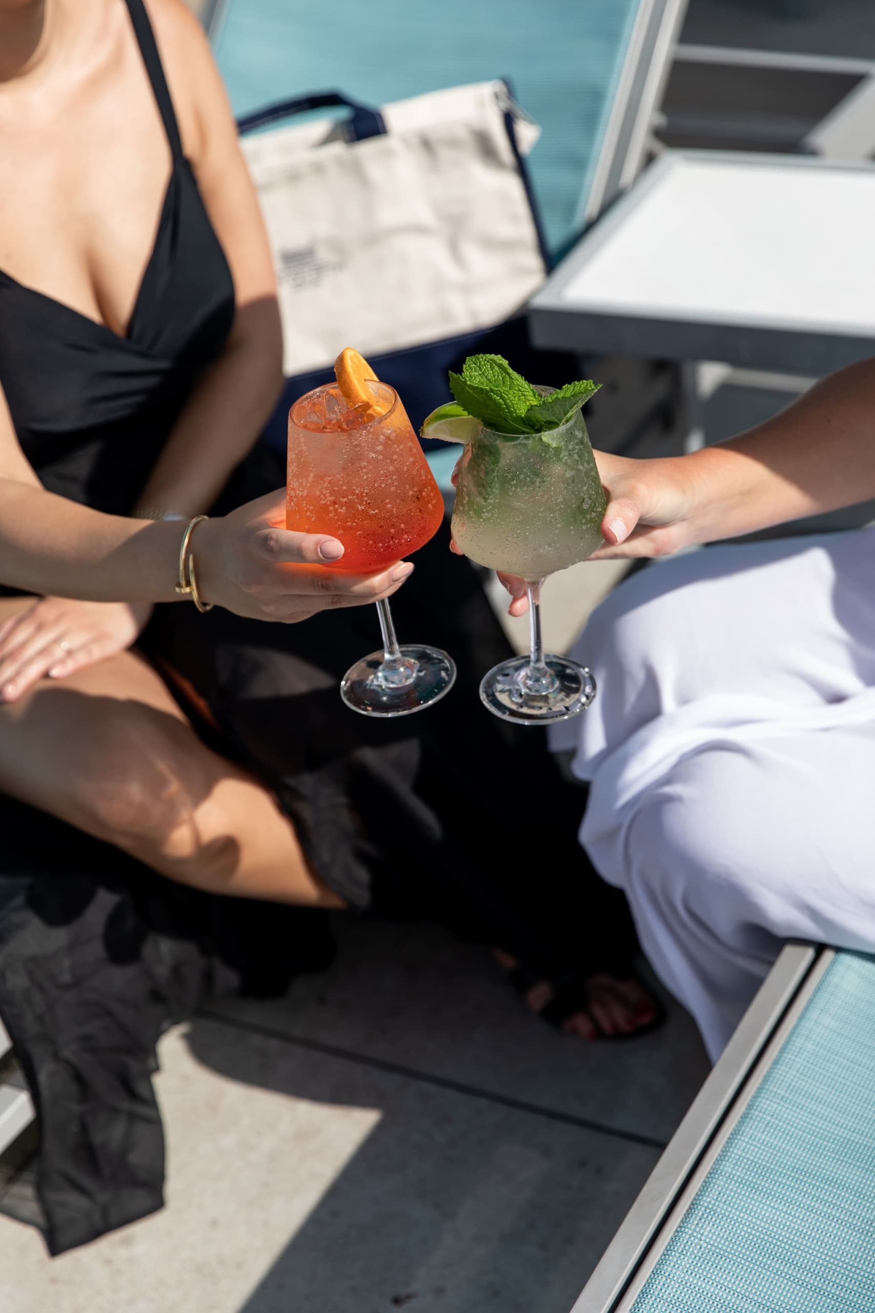 Guests toasting with cocktails poolside at Inn on Fifth in Naples, Florida