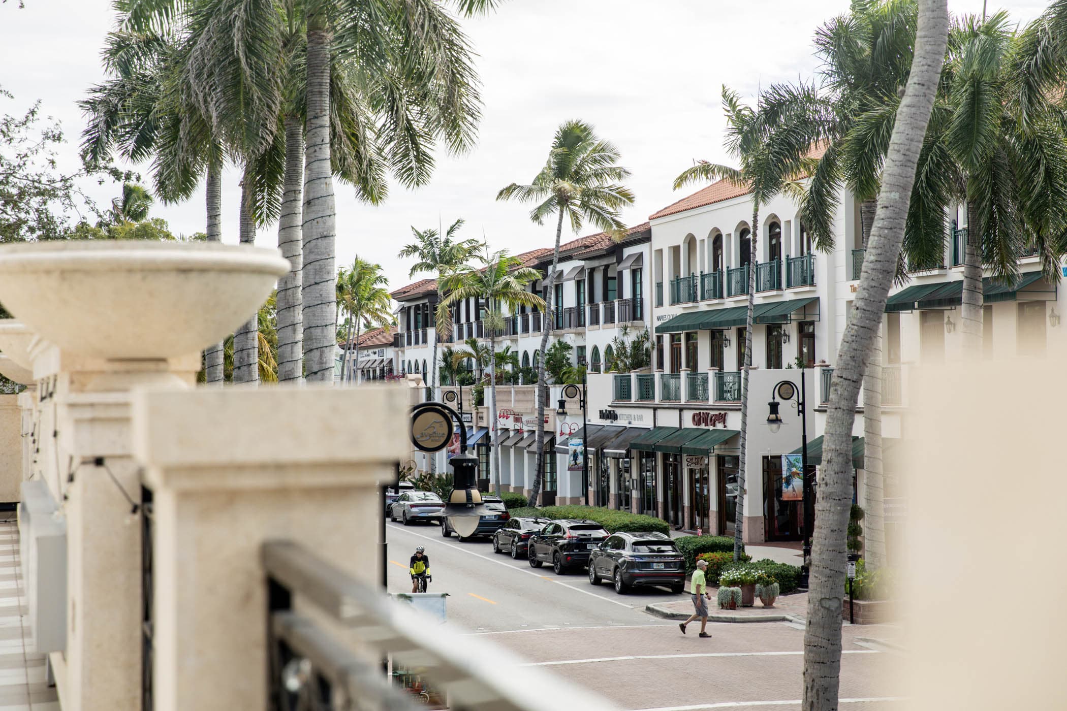 Shops and palm trees along Fifth Avenue South in downtown Naples, Florida