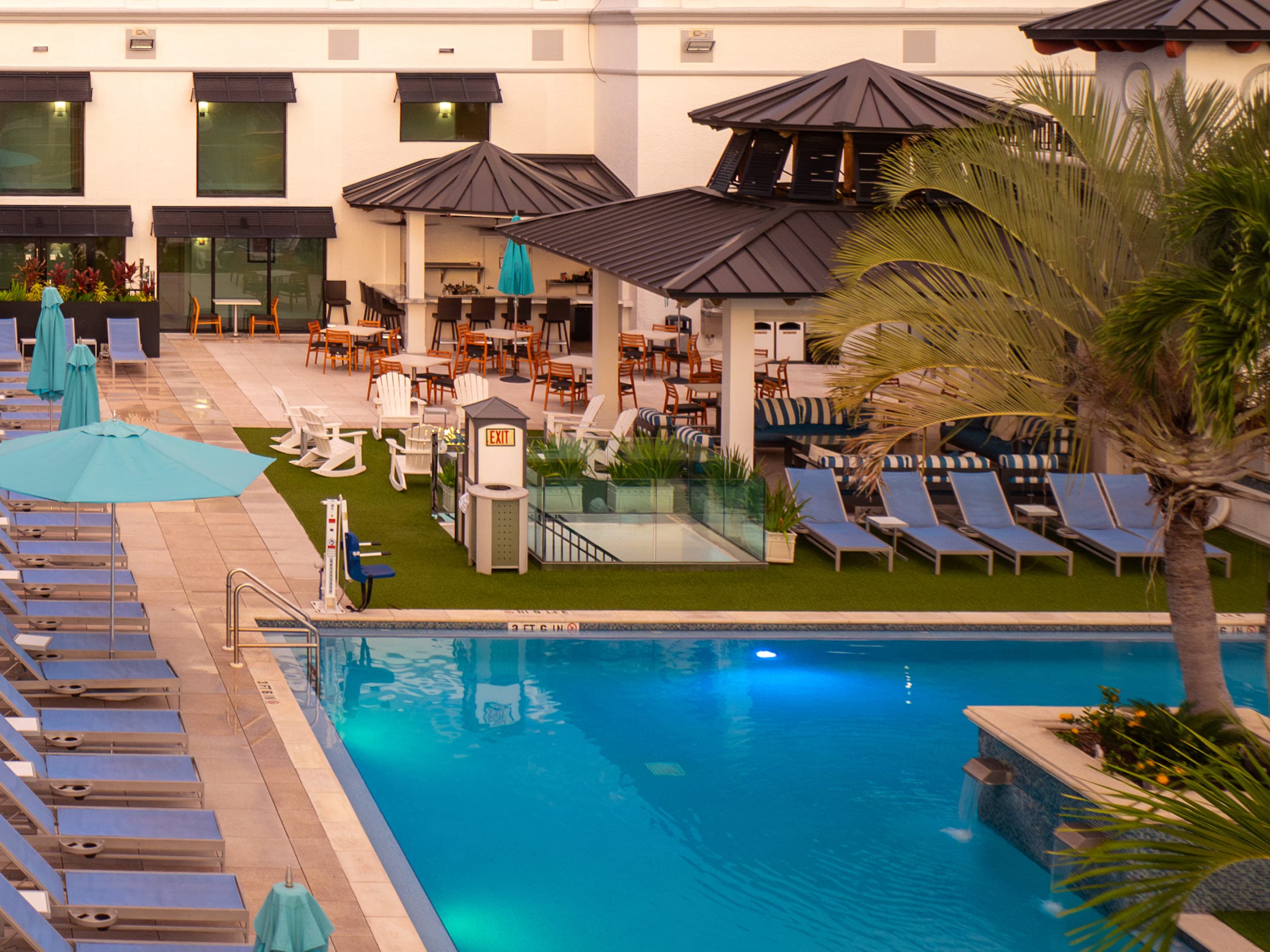 Rooftop pool with loungers and thatched cabanas at Inn on Fifth, Naples, FL