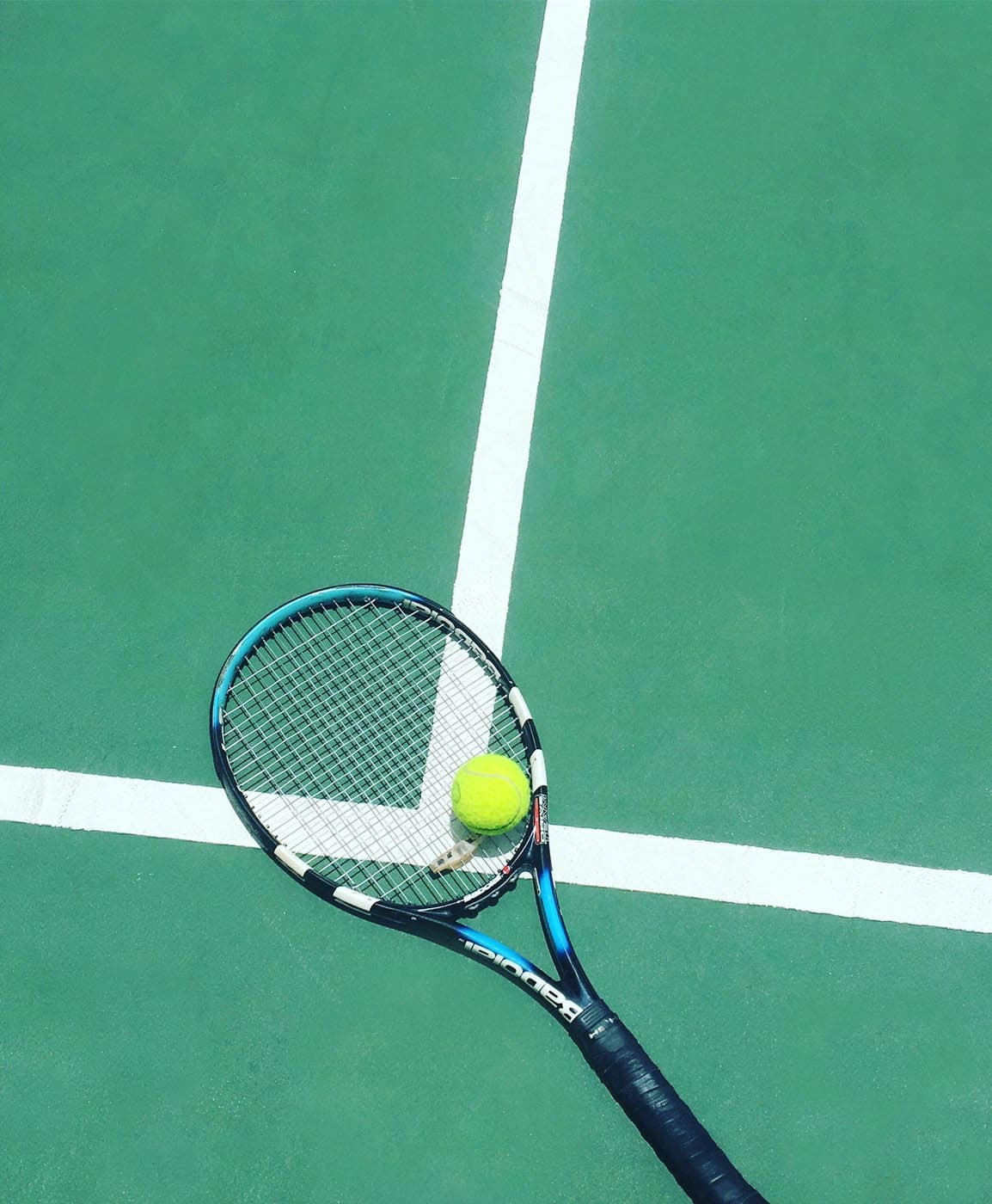Tennis racket and ball on the court at a tennis club in Naples, Florida