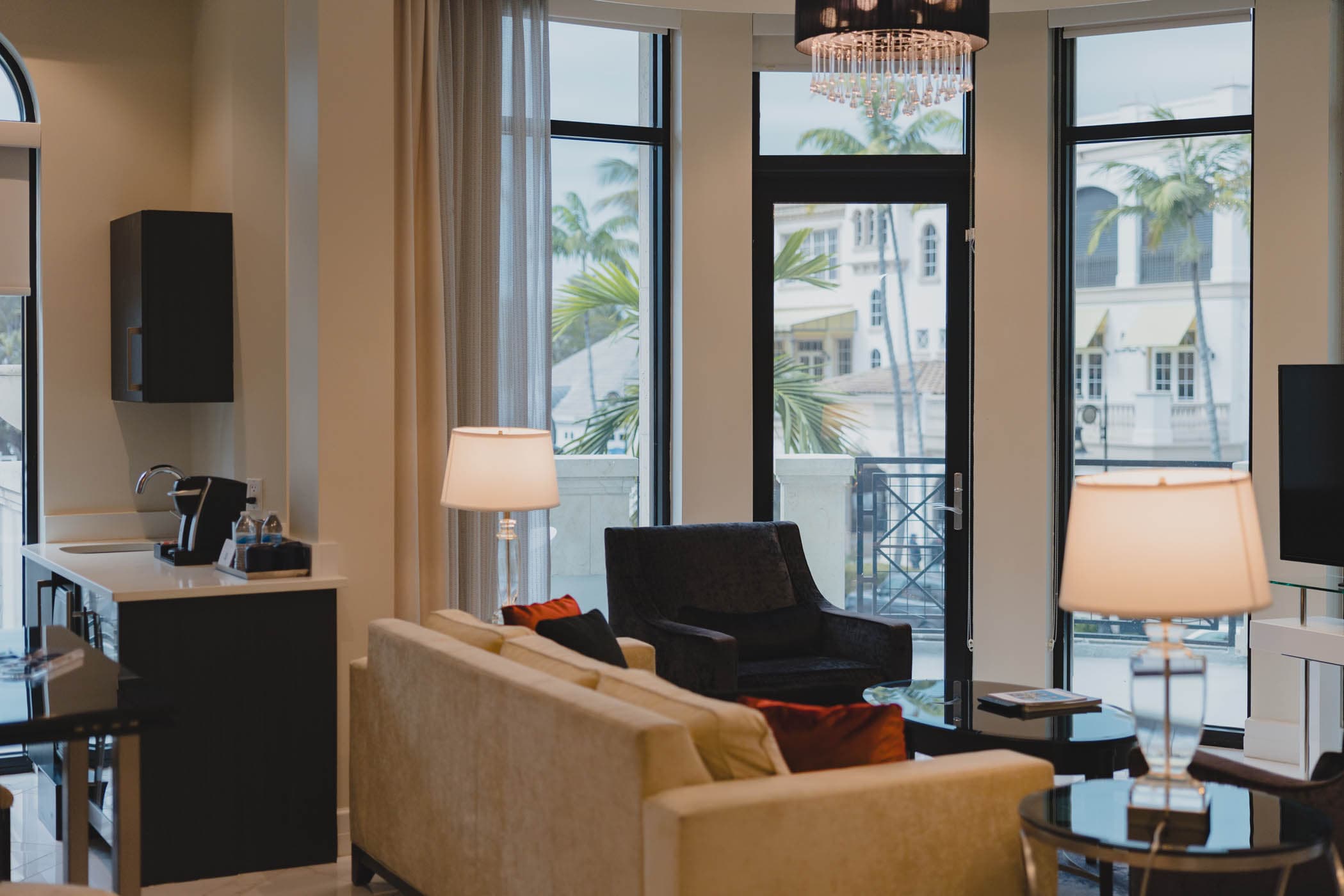 Hospitality suite with armchairs and city views at Inn on Fifth in Naples, FL