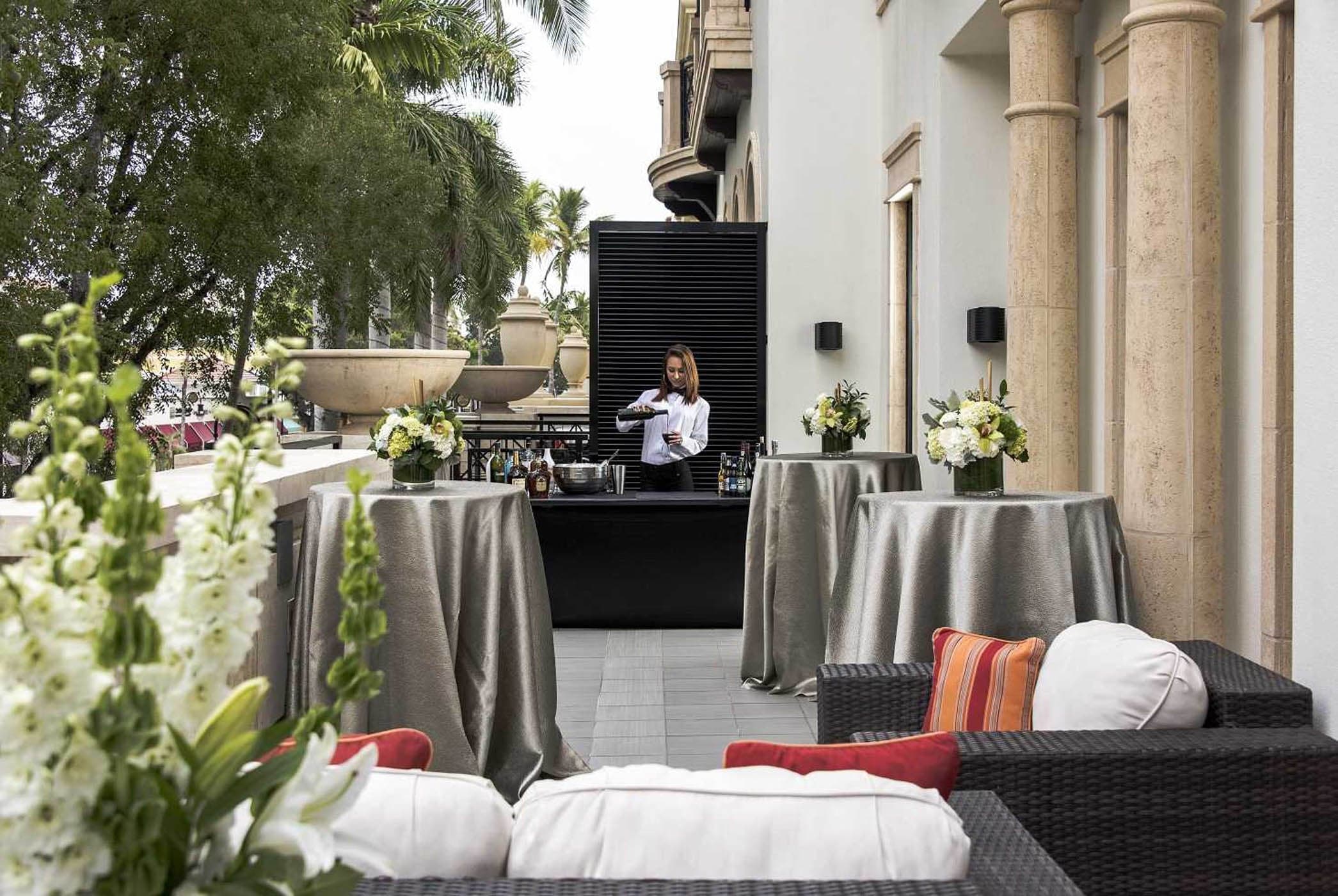 Private outdoor event lounge with bar and seating at Inn on Fifth in Naples, Florida