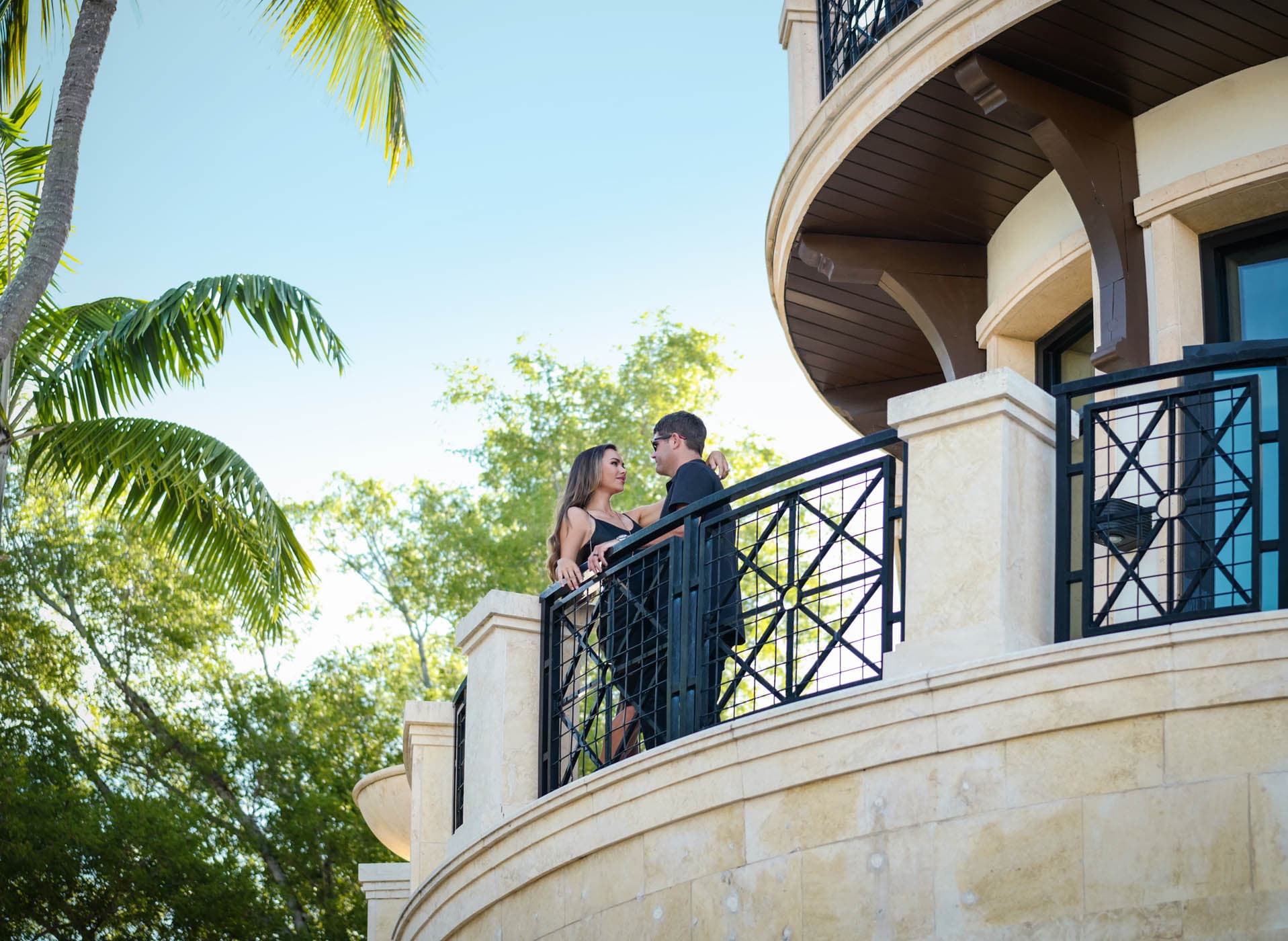 Couple on a wrought iron balcony at Inn on Fifth in downtown Naples, Florida